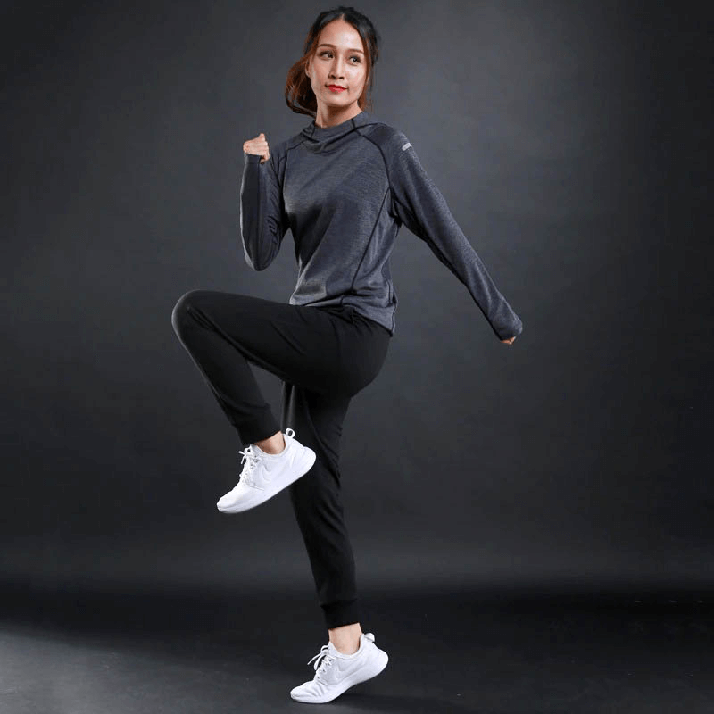 Woman exercising in a sports gym fitness reflective printing hoodie, SF0097, featuring breathable long sleeves, ideal for active athletes.